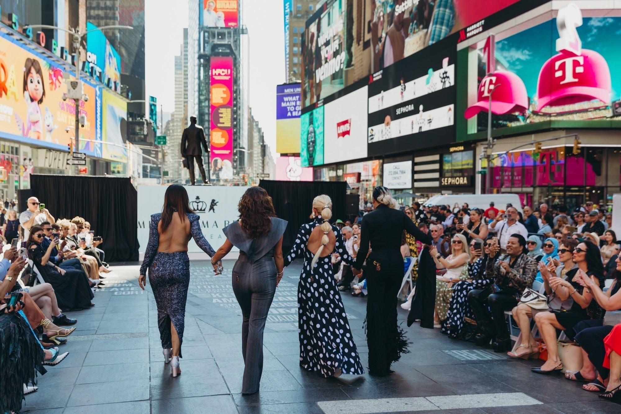 Models showcasing Black Diamond, Fringy Baby, Dark Denim Nights, Supernova, and Sexy Day during their debut at the Times Square Fashion Show, NYC.