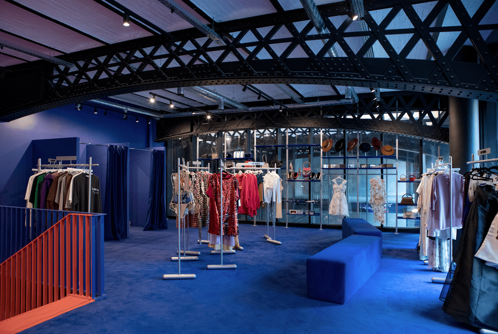 Flying Solo Paris - Modern fashion retail space showcasing vibrant clothing displays against a striking blue backdrop.