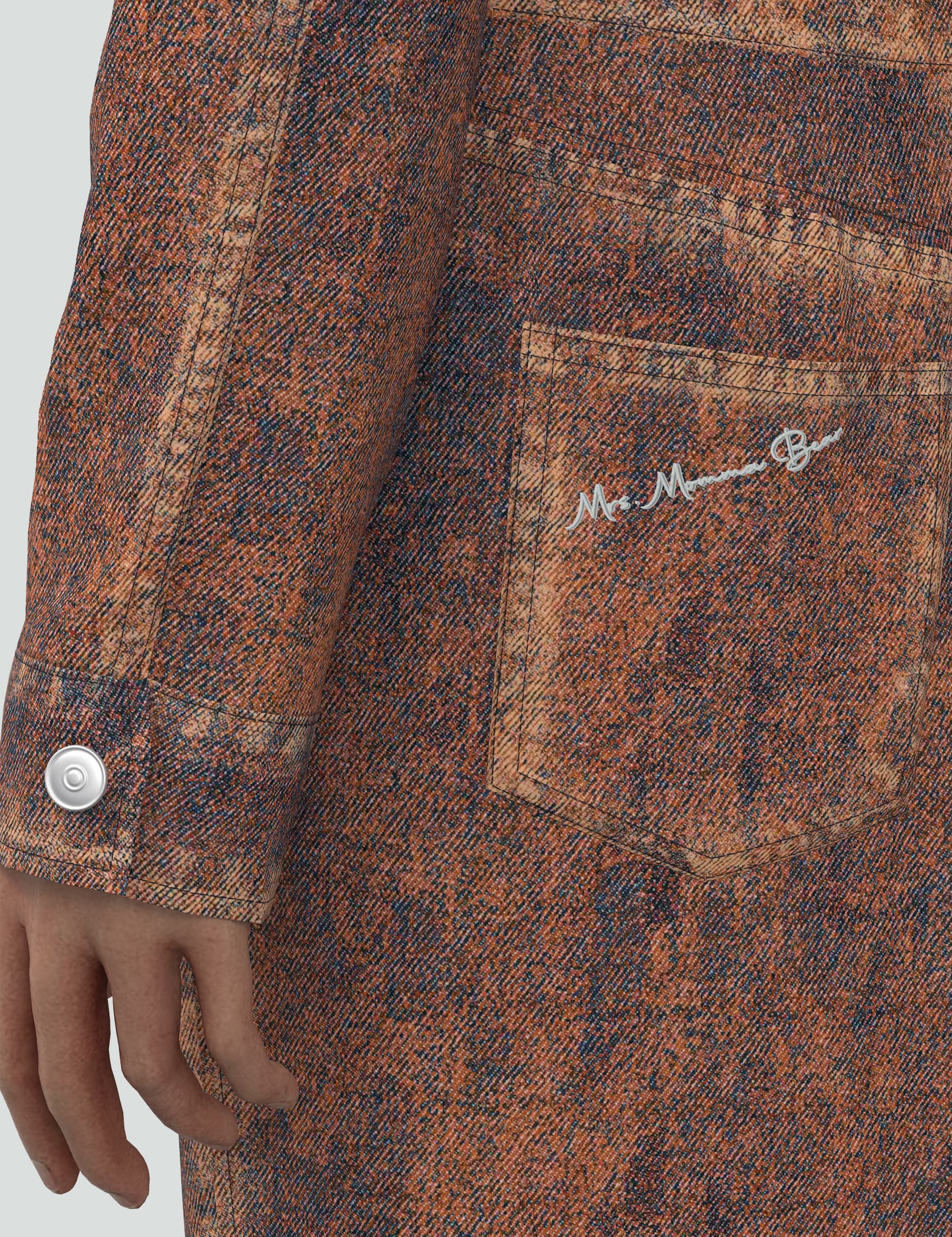 Close-up of orange denim mini dress showcasing pocket detail and signature fabric texture.