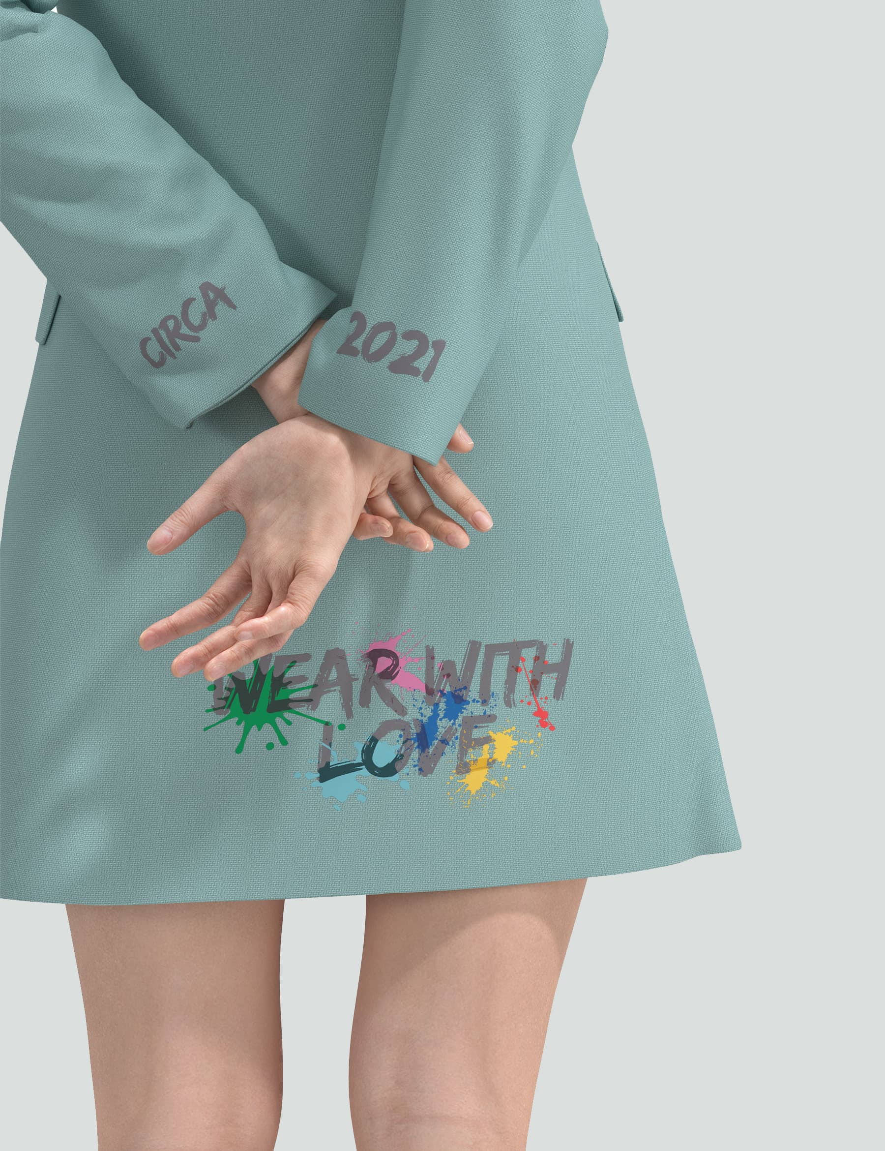 Detailed view of the sea green mini tuxedo dress featuring "Wear with Love" logo and stylish sleeves.