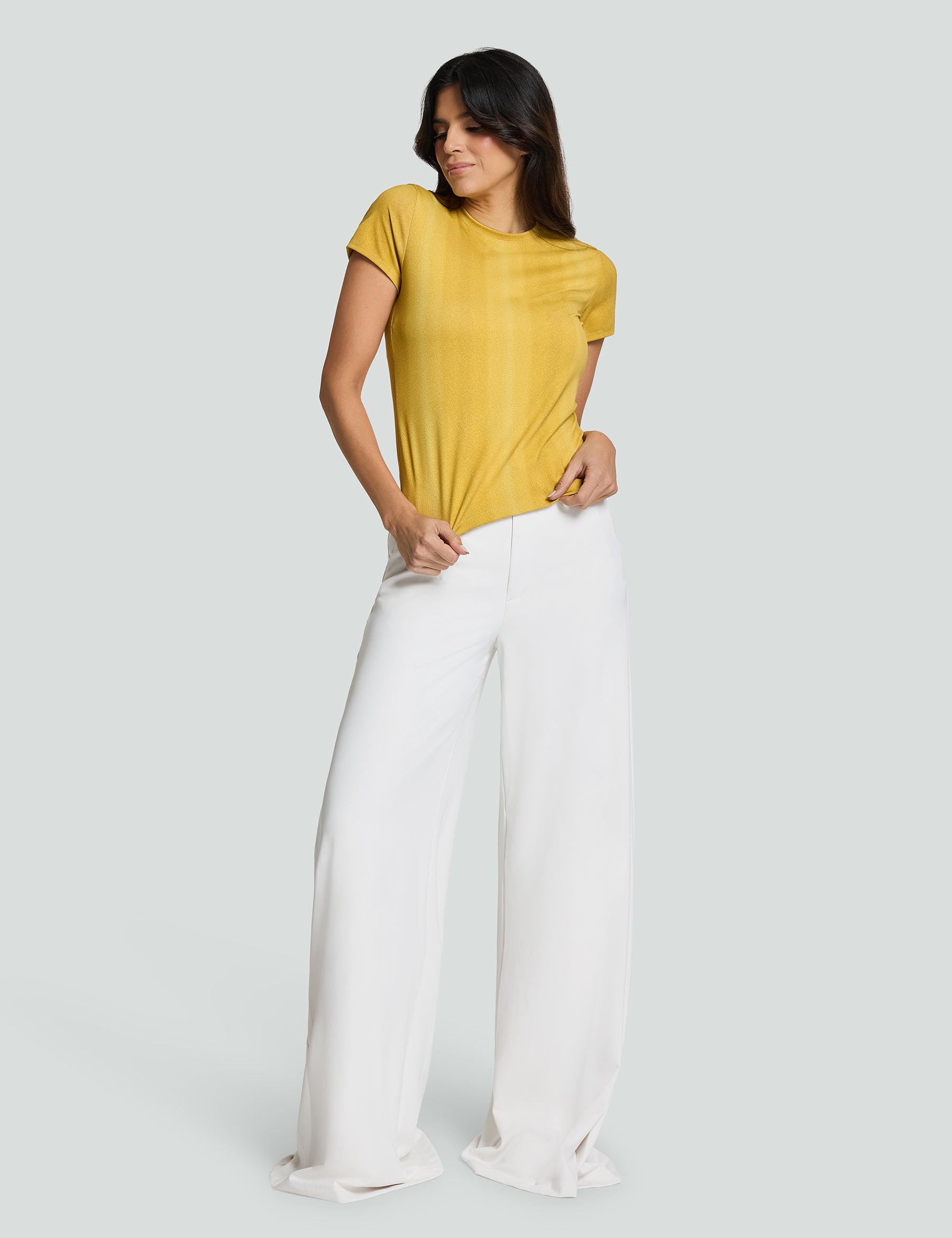 Model wearing Signature Luxe Tee in yellow with white wide-leg pants, showcasing a stylish casual look.