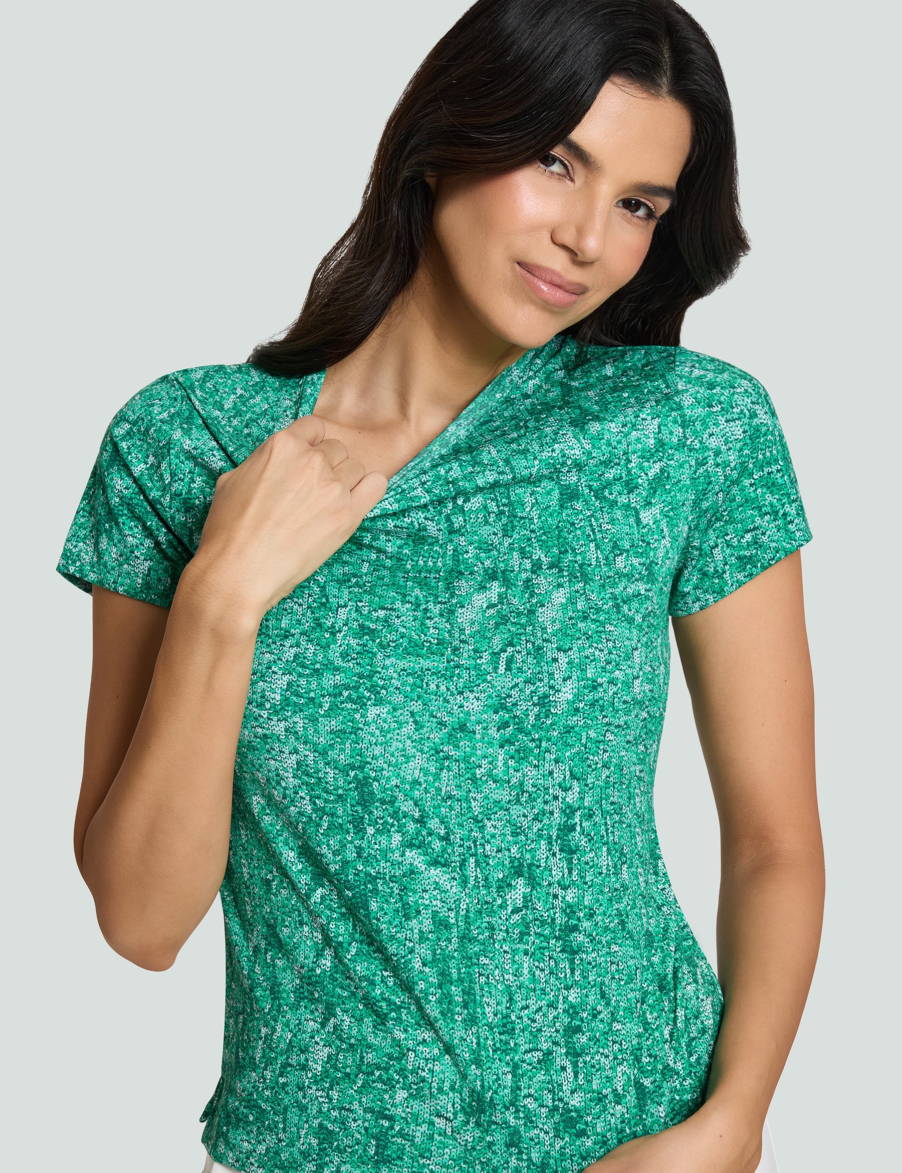 Model wearing the Signature Luxe Tee in Verde Mi Amor, showcasing green sequin print and a comfortable fit.